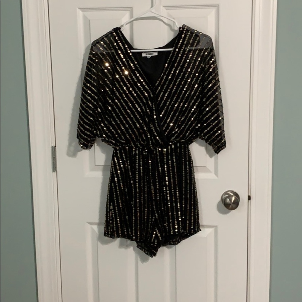 Black romper with gold sequins.